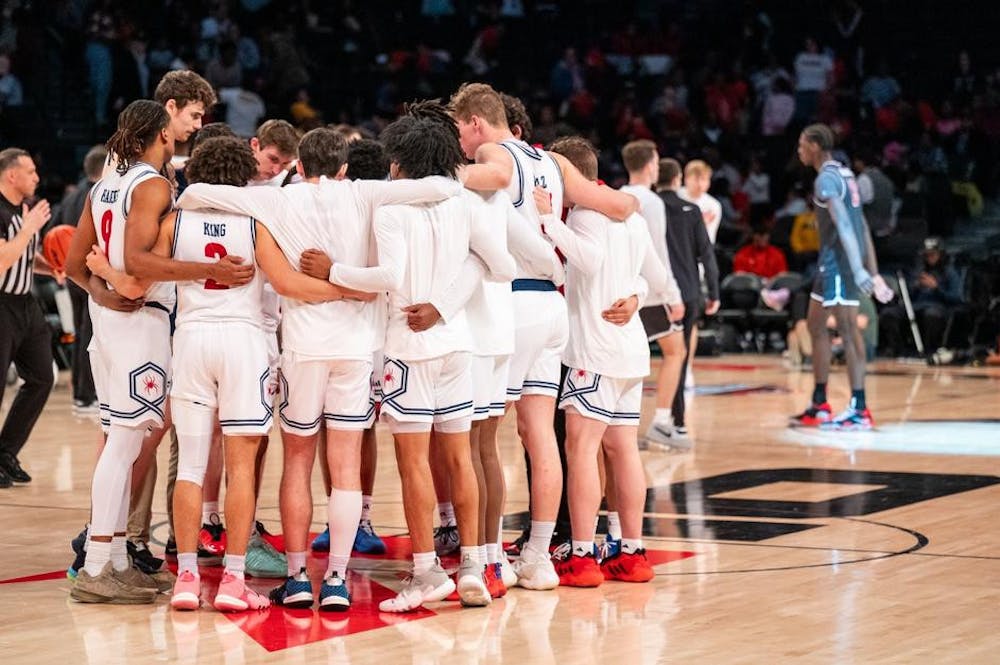 University of Richmond players confer during the March 15 game against Saint Joseph's University. Courtesy of Richmond Athletics.
