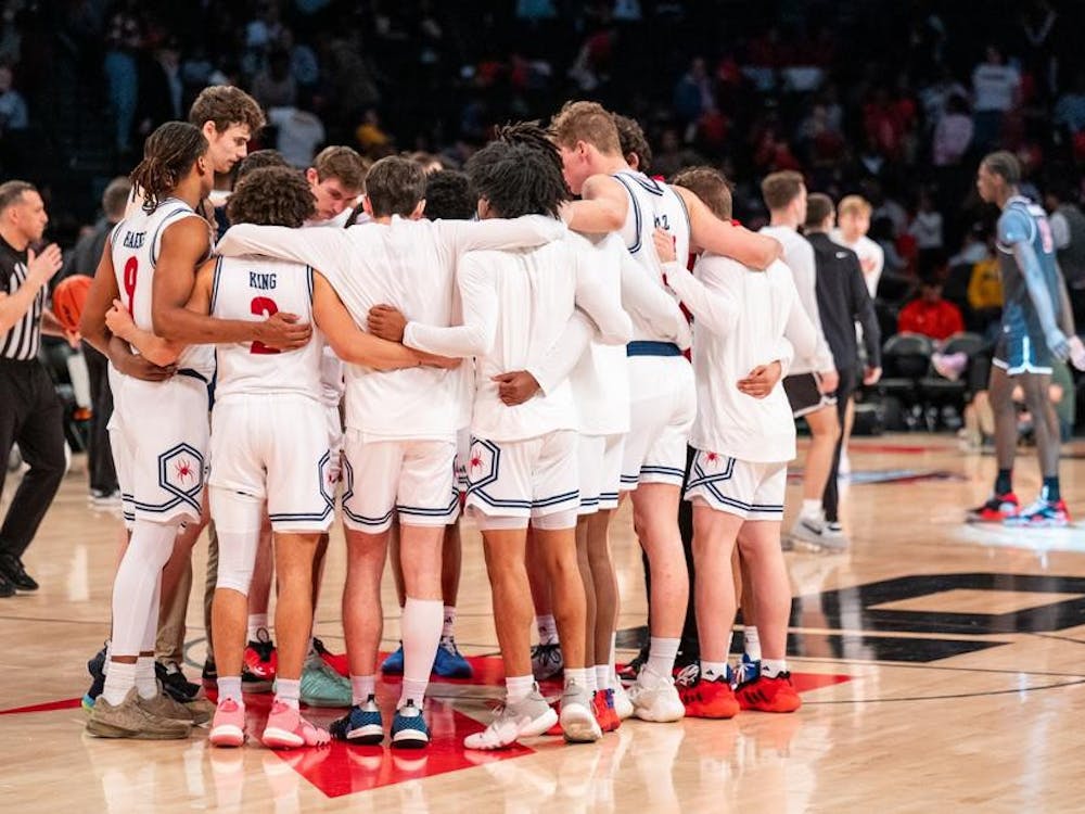 University of Richmond players confer during the March 15 game against Saint Joseph's University. Courtesy of Richmond Athletics.