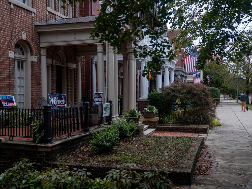 A collage of election signs cover a house on Monument ave.