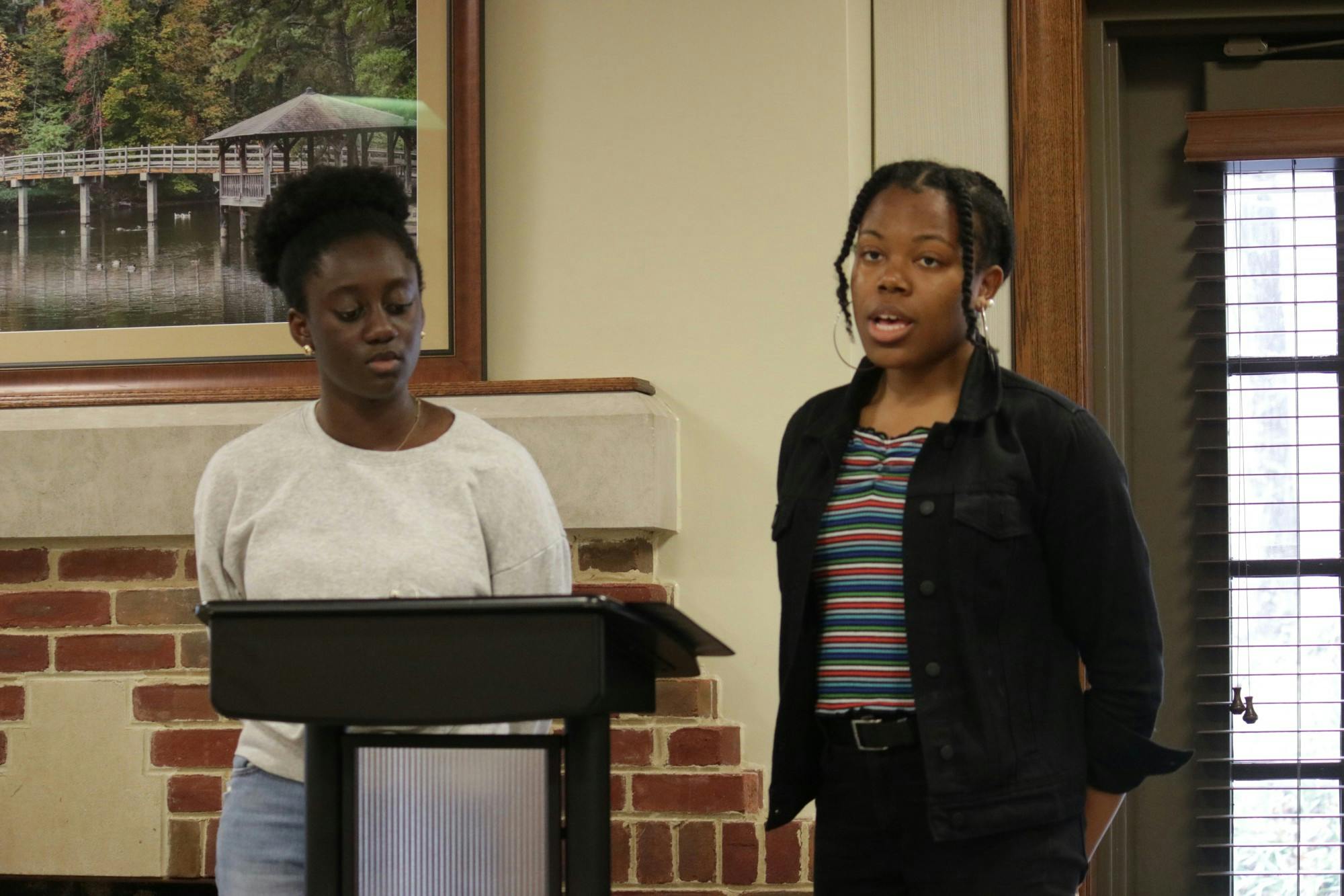 First-year Cheryl Oppan and senior Regenia Miller read a poem by Amanda Gorman.