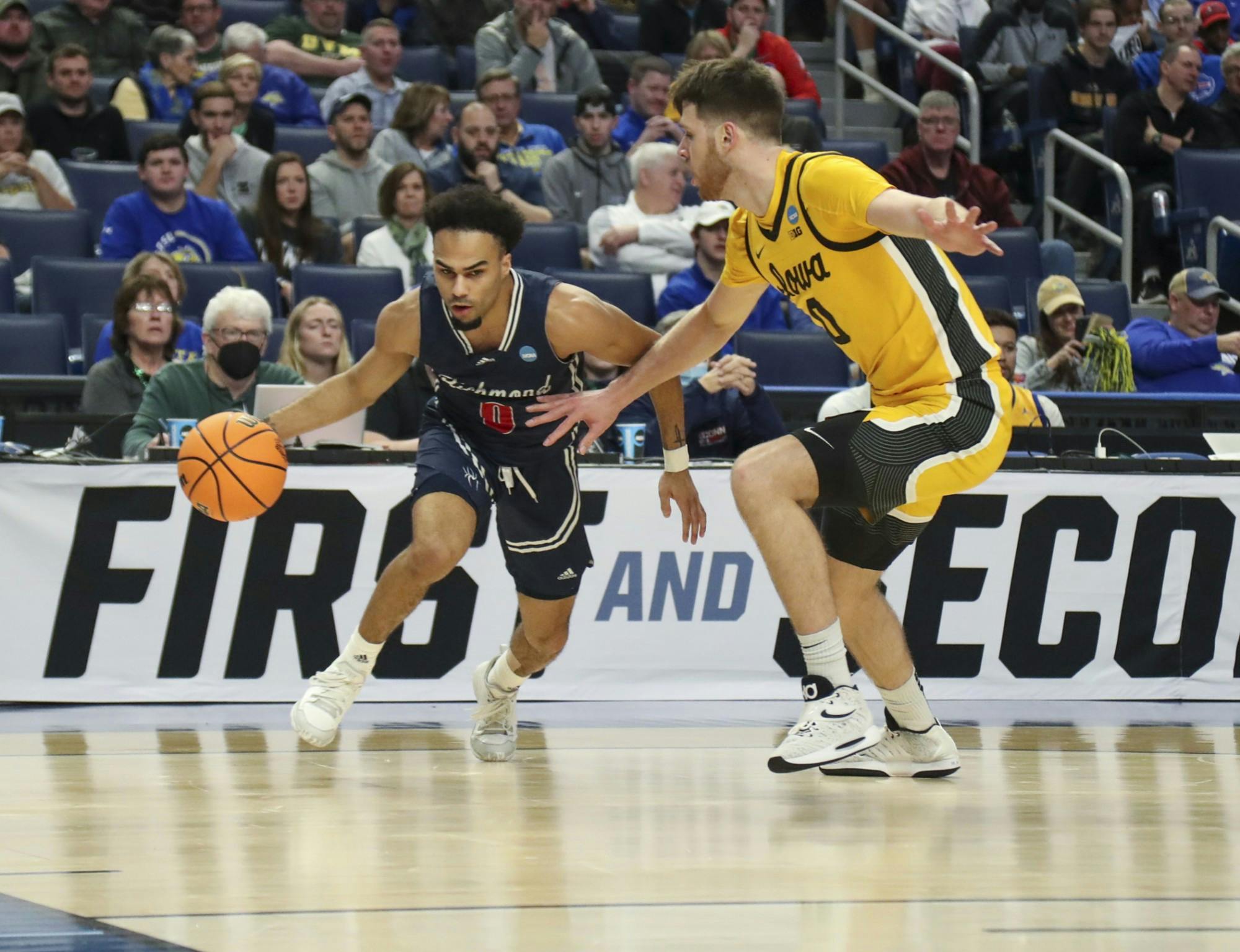 Graduate guard Jacob Gilyard dribbles past a University of Iowa player during the second half of play in the first round of the NCAA Men's Basketball Tournament at the KeyBank Center on March 17, 2022 in Buffalo, New York. Photo by Nicholas LoVerde and courtesy of Richmond Athletics.