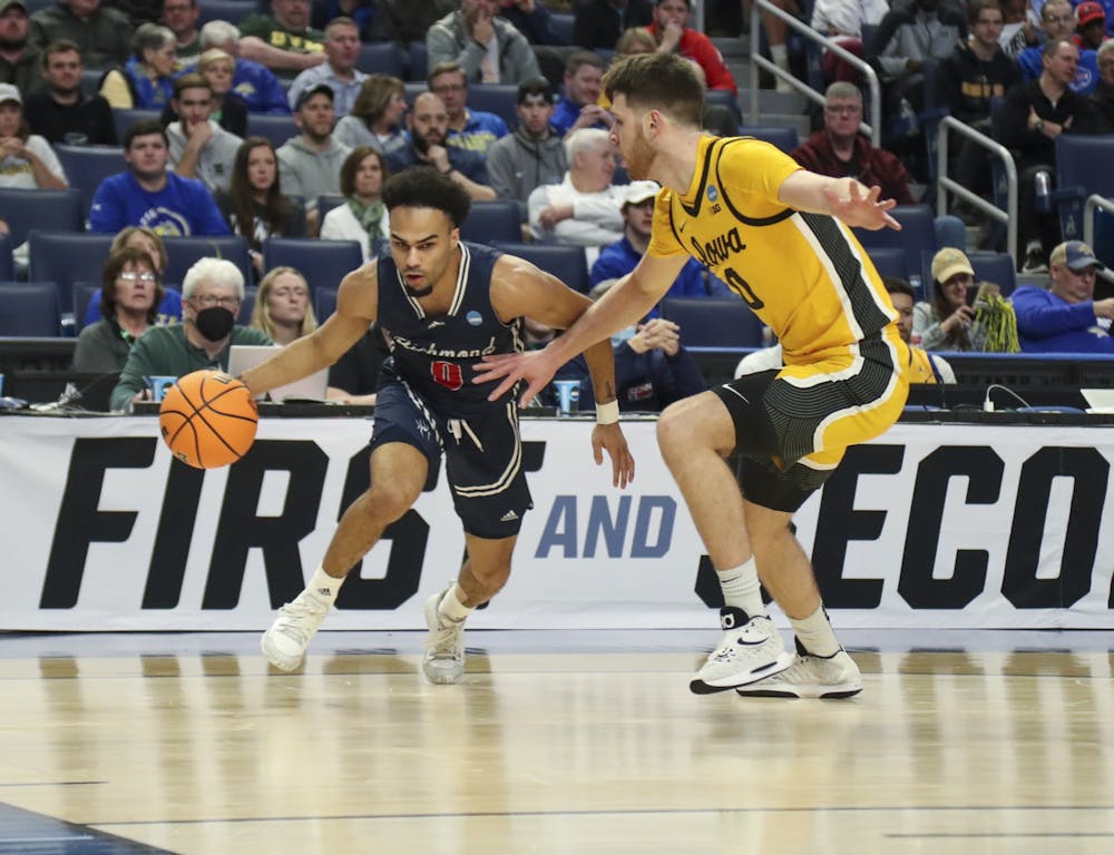 <p>Graduate guard Jacob Gilyard dribbles past a University of Iowa player during the second half of play in the first round of the NCAA Men's Basketball Tournament at the KeyBank Center on March 17, 2022 in Buffalo, New York. Photo by Nicholas LoVerde and courtesy of Richmond Athletics.</p>