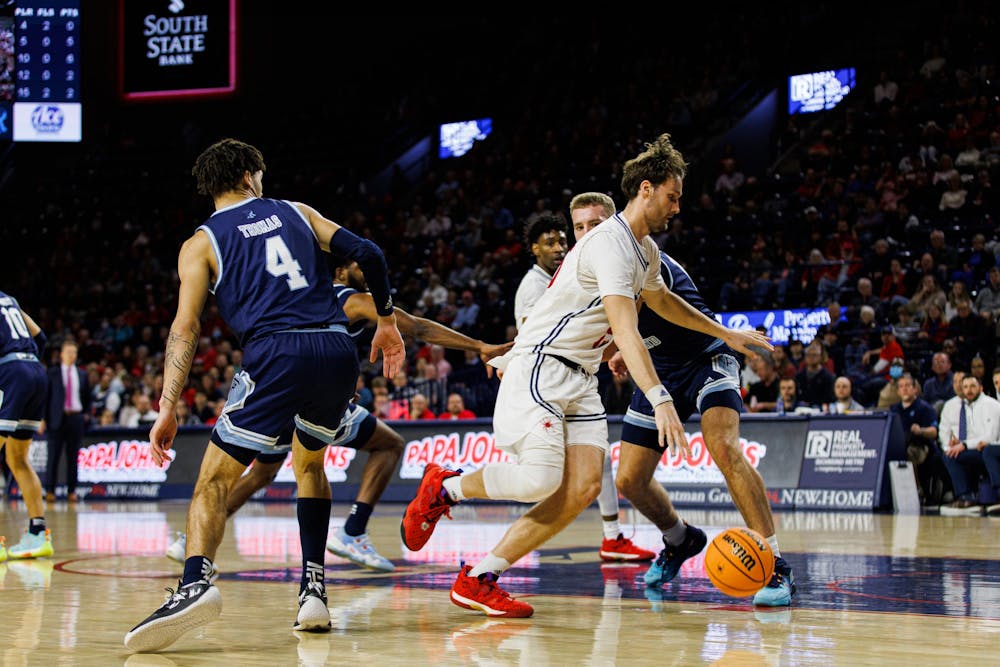 <p>Graduate Forward, Matt Grace drives to the basket for a layup in the first half against Rhode Island.</p>