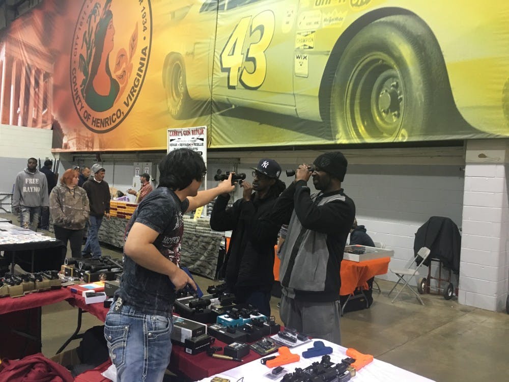 Two men examine a VZR Close Quarter Combat Scope (Retail Price: $119).