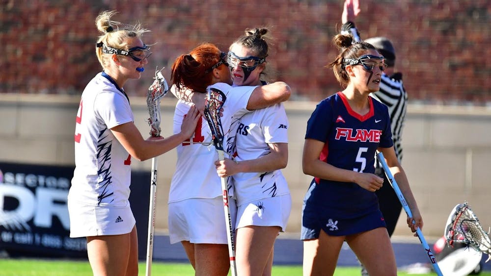 <p>Women's lacrosse players congratulate one another during game against Liberty University on Feb. 8. Photo courtesy of Richmond Athletics.&nbsp;</p>
