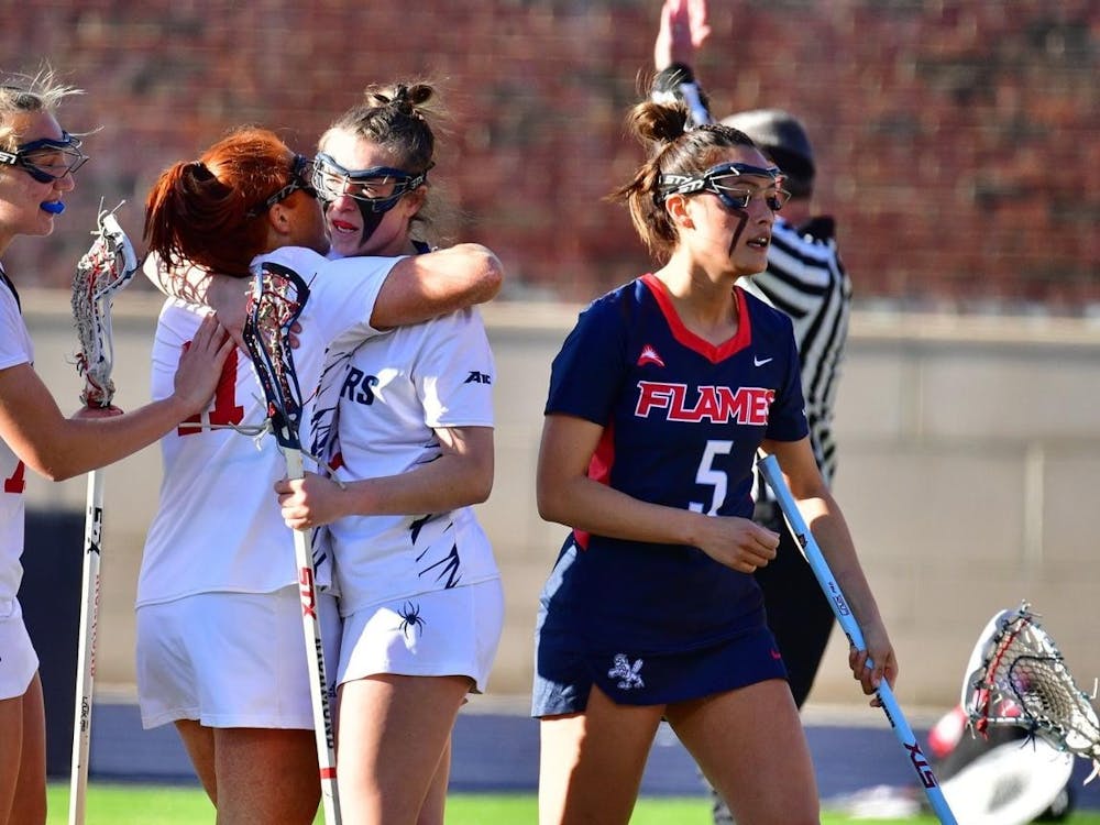 Women's lacrosse players congratulate one another during game against Liberty University on Feb. 8. Photo courtesy of Richmond Athletics. 