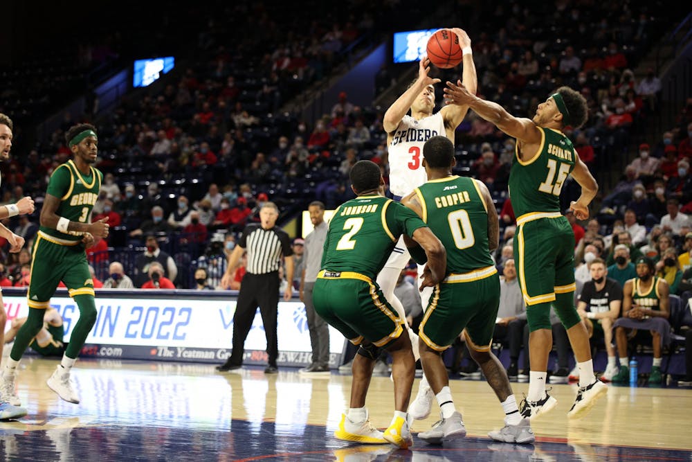 Junior forward Tyler Burton goes for a shot in the University of Richmond's game against George Mason University. 