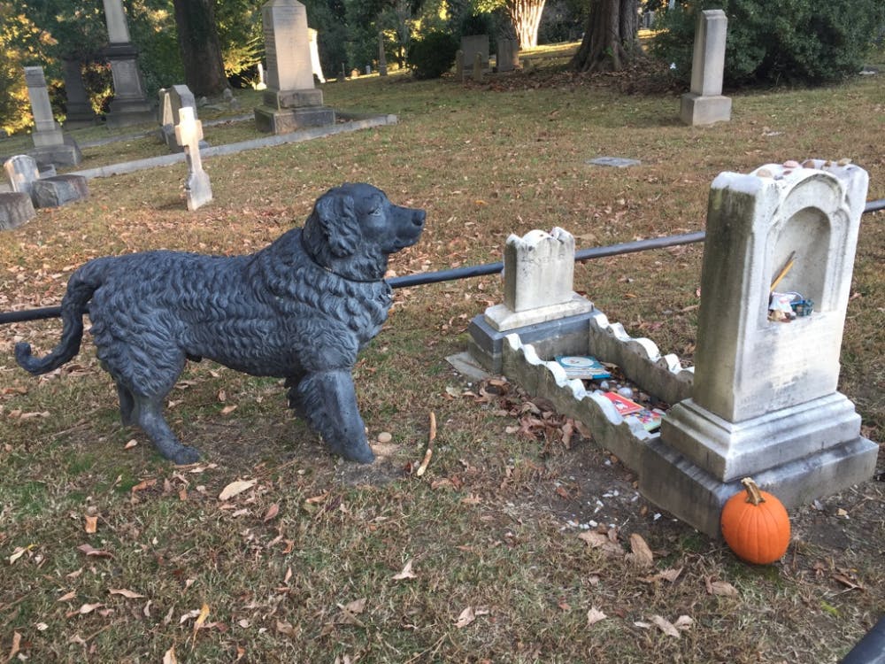 <p>A cast-iron Newfoundland dog stands guard over the grave of a toddler who died in 1862 at the Hollywood Cemetery in Richmond.</p>