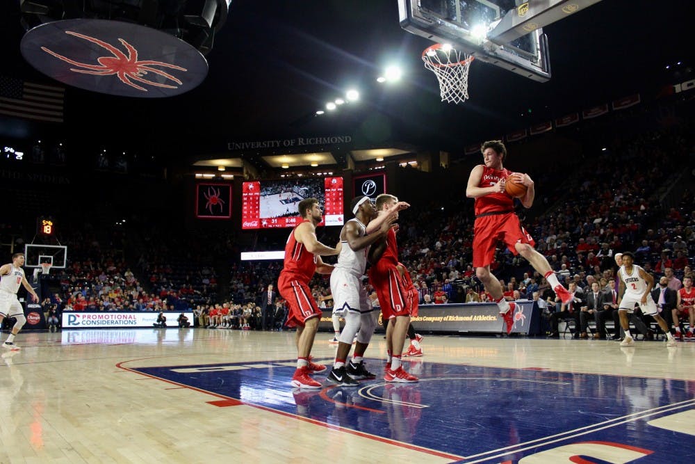 Davidson guard, Rusty Reigel, goes up for a rebound in the first half.