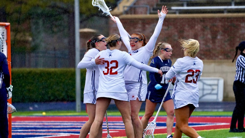 Junior attacker Juliana Stanley, freshman attacker Stella Axe, senior attacker Colleen Quinn, and junior attacker Alexis Morton celebrating goal.