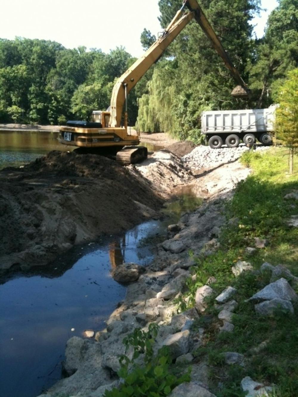 <p>A bulldozer works to clean up Westhampton Lake.</p>