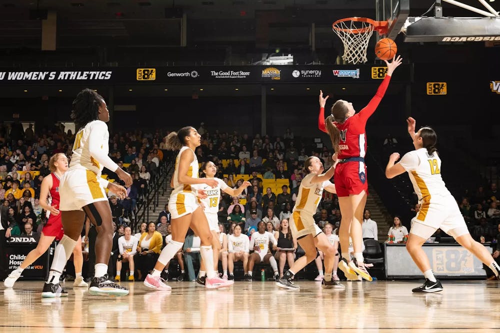 <p>Doogan scores in game that secured championship title for UR women's basketball. Photo courtesy of Spider Athletics.</p>