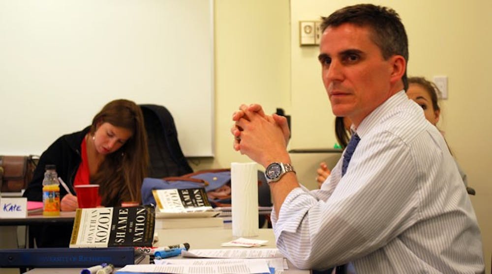 Tom Shields is seen discussing with students of his LDST 205- Justice and Civil Society class.
