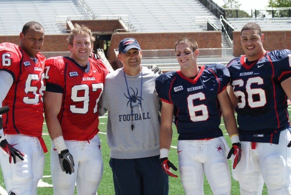 <p>Kerry Wynn (far left) with head coach Danny Rocco and fellow captains in April 2013.</p>