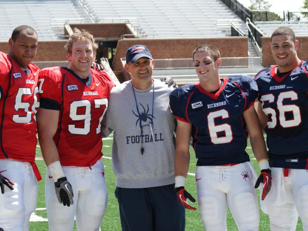 Kerry Wynn (far left) with head coach Danny Rocco and fellow captains in April 2013.