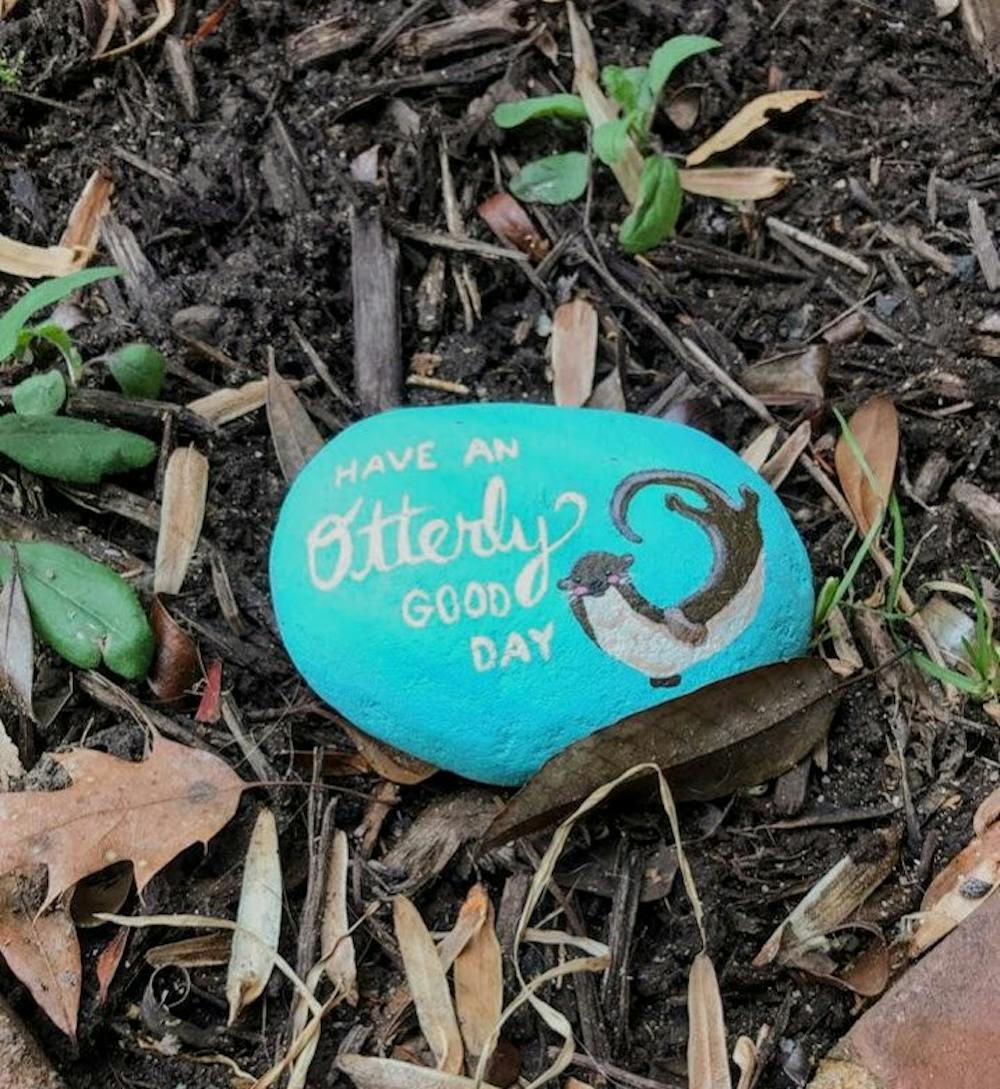 <p>An anonymous student leaves her hand-painted "kindness rocks" around campus in order to spread positivity and happiness. Photo c<em>ourtesy of anonymous artist.</em></p>