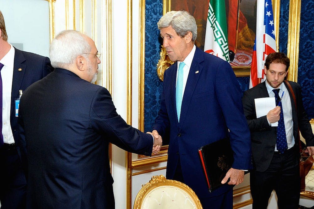 <p>U.S. Secretary of State John Kerry shakes hands with Iranian Foreign Minister Mohammad Javad Zarif in Vienna, Austria, on July 13, 2014, before they begin a bilateral meeting focused on Iran's nuclear program | State Department photo/ Public Domain</p>