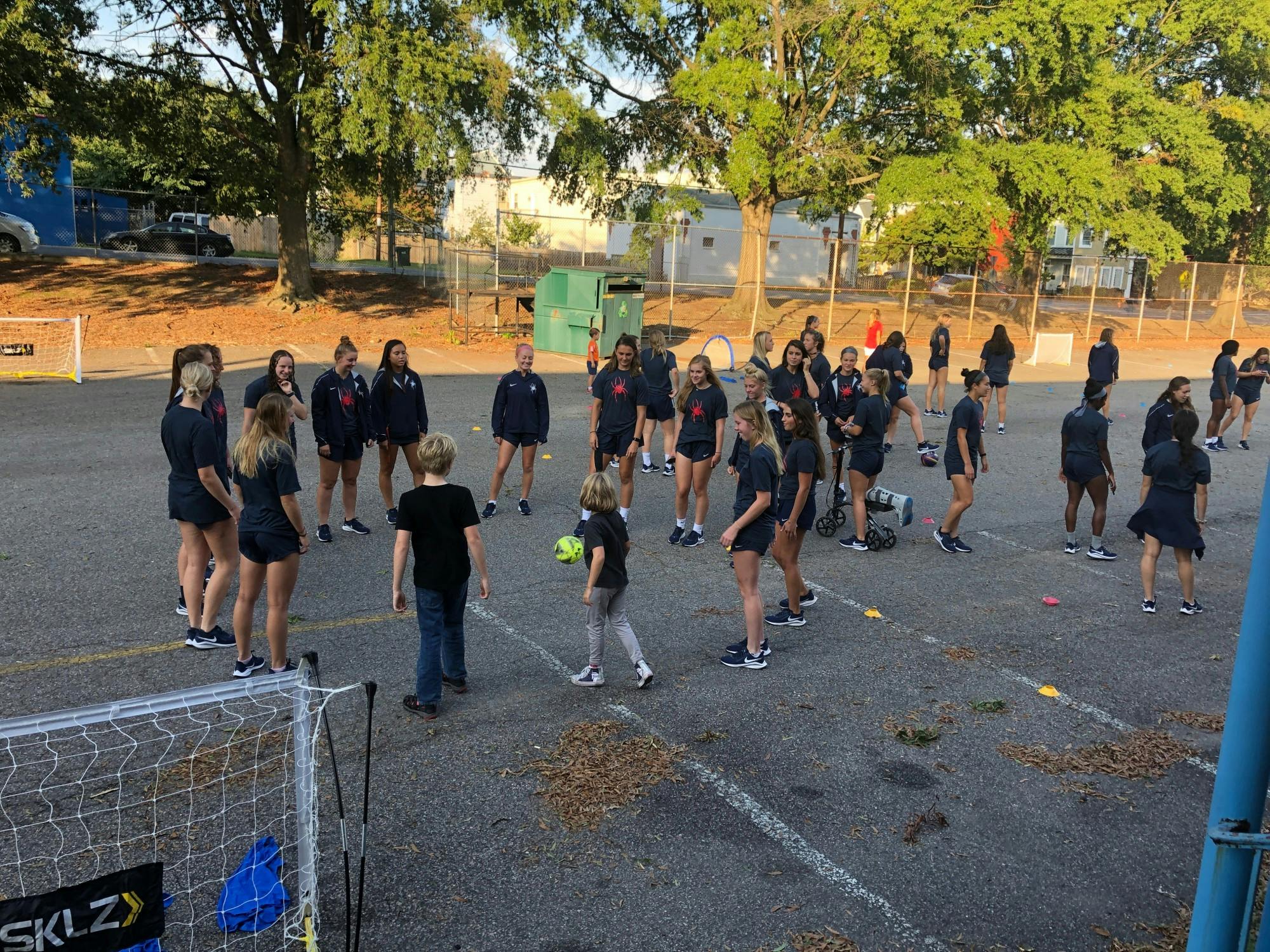 Members of the University of Richmond women's soccer team teach street soccer to local elementary schoolers. Photo courtesy of Street Soccer RVA