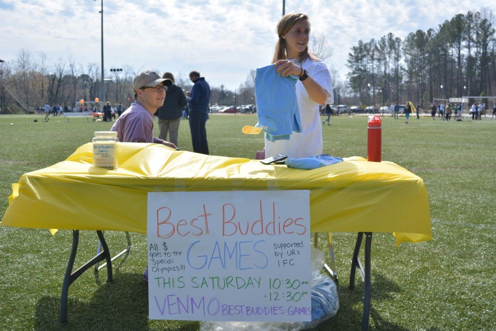 Juniors Tyler Deen and Julia Selman sell Best Buddies t-shirts on the IM fields.