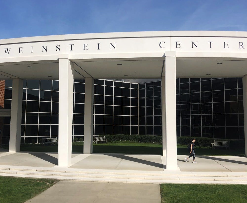 <p>A student walks out of the Weinstein Center for Recreation and Wellness.</p>