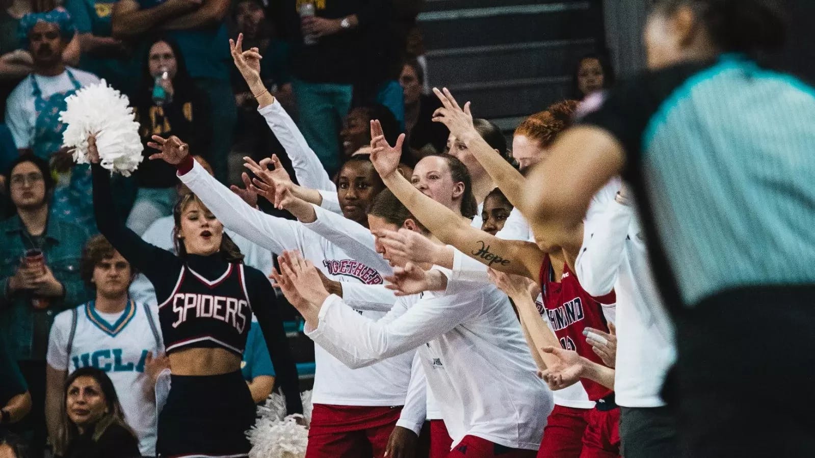 The UR women's basketball team cheers from the sidelines of the NCAA tournament game. Courtesy of Richmond Athletics