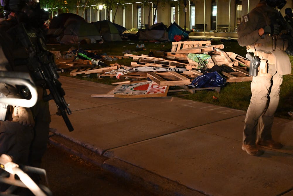 <p>Remnants of barrier created by protesters that was torn down by police along with signs taken from the encampment.</p>