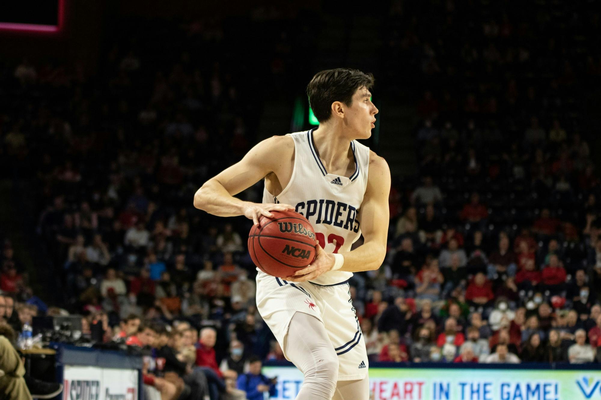 Senior guard Andre Gustavson surveys the court as he looks to pass the ball during the game against Saint Louis University on Feb. 25.