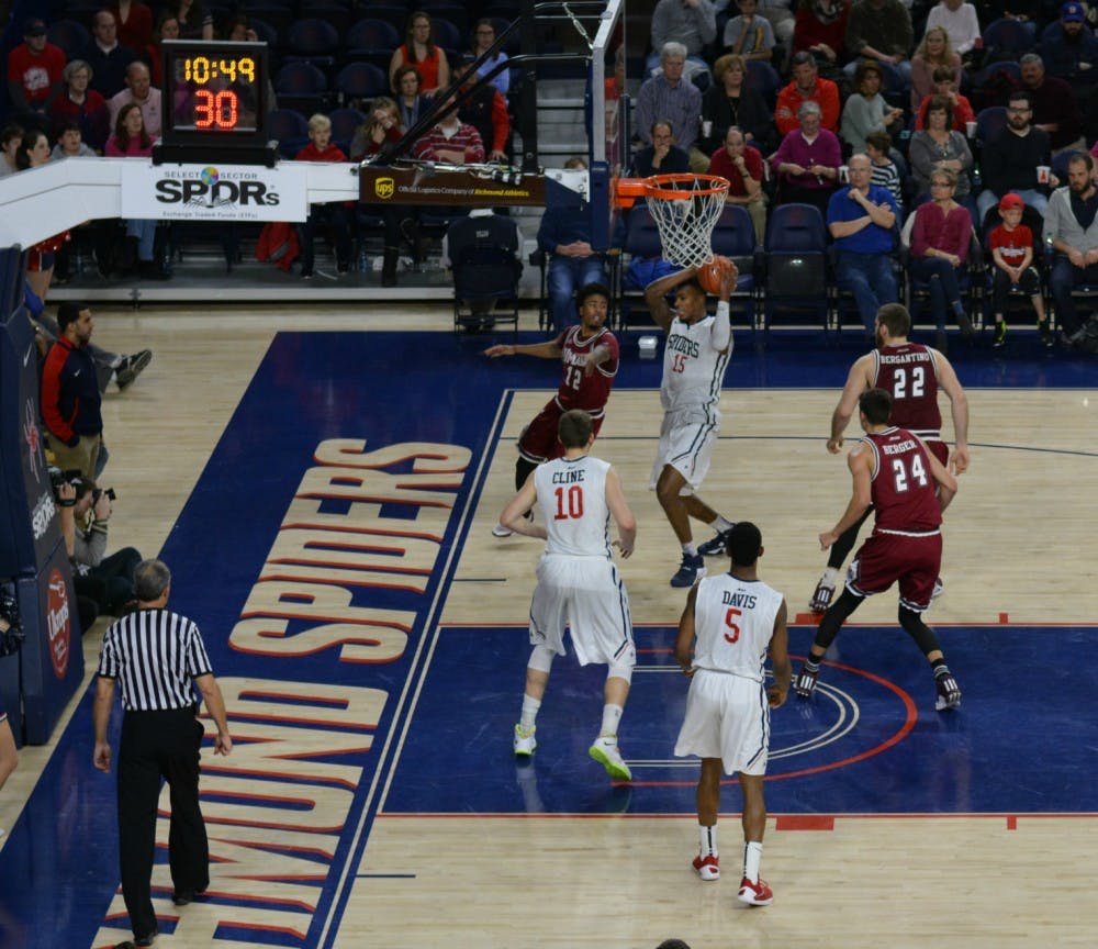 Allen drives toward the hoop as Scott Dankenbring, sitting behind the camera, watches from the stands.&nbsp;