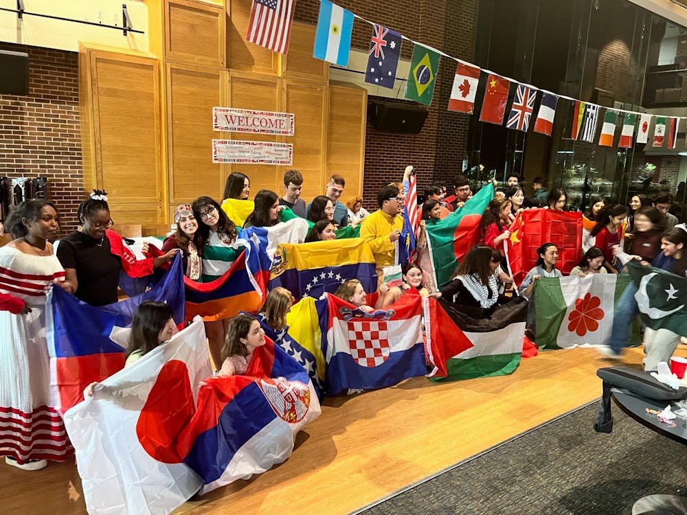<p>Students representing their country at the International Club's fair on Nov. 12 pose with flags. Photo courtesy of &nbsp;sophomore Anush Margaryan.&nbsp;</p>