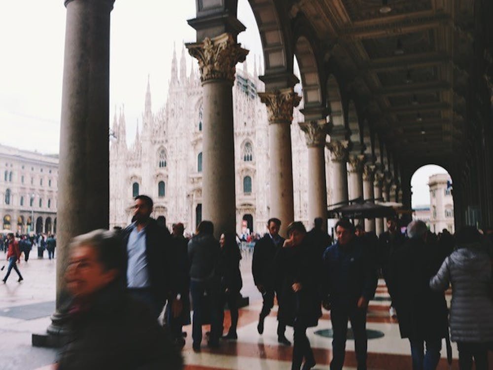 A crowded sidewalk beside the Milan Cathedral.&nbsp;