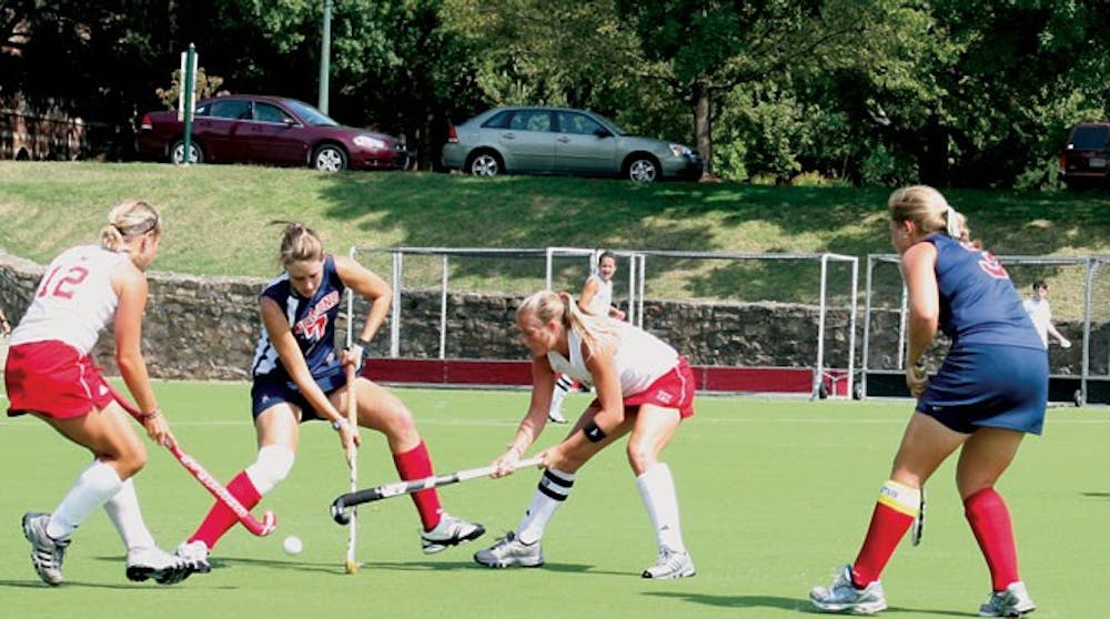 During Women's Field Hockey game versus Miami University Dani Pycroft who is a junior player attempts to pass the ball and Sarah Blythe-Wood  who is a senior players assits Dani's playing. 