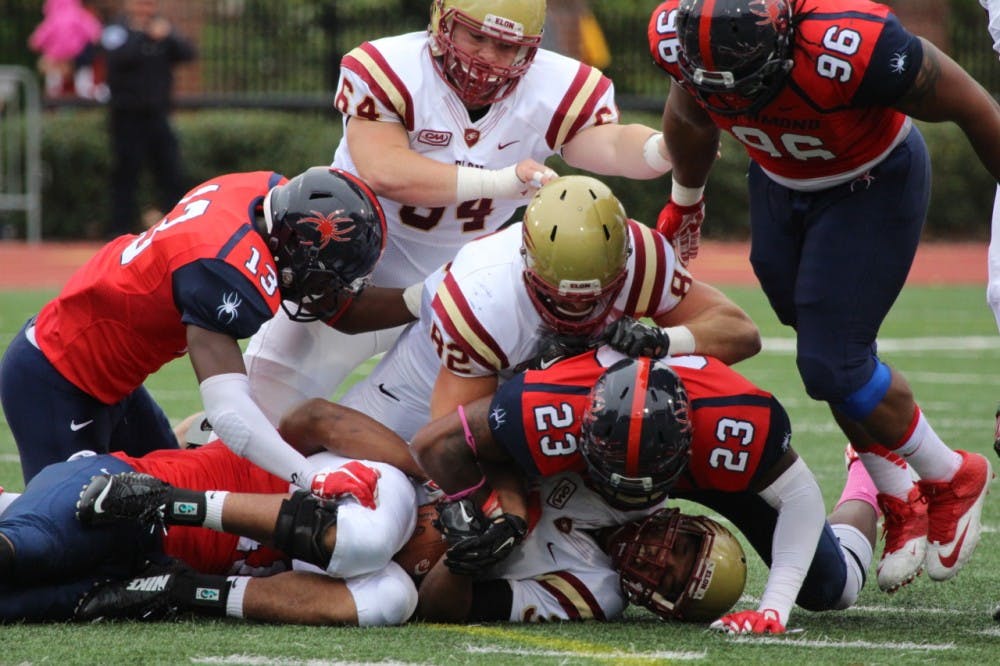 <p>Richmond linebacker Selton Hodge (23) smothers an Elon runner. The Richmond defense controlled Elon on Saturday, holding the team to just 150 yards through the first three quarters before second-string players took over for the Spiders. </p>