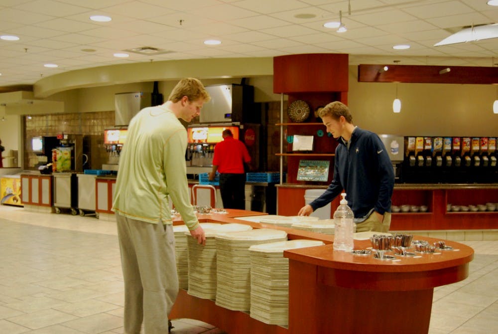 Sophomores Ryan Shepard (left) and Andrew McInerney (right) grab trays at the Heilman Dining Center.&nbsp;
