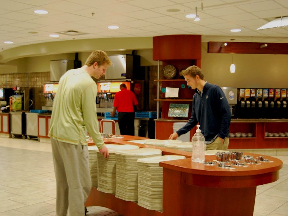 Sophomores Ryan Shepard (left) and Andrew McInerney (right) grab trays at the Heilman Dining Center.&nbsp;