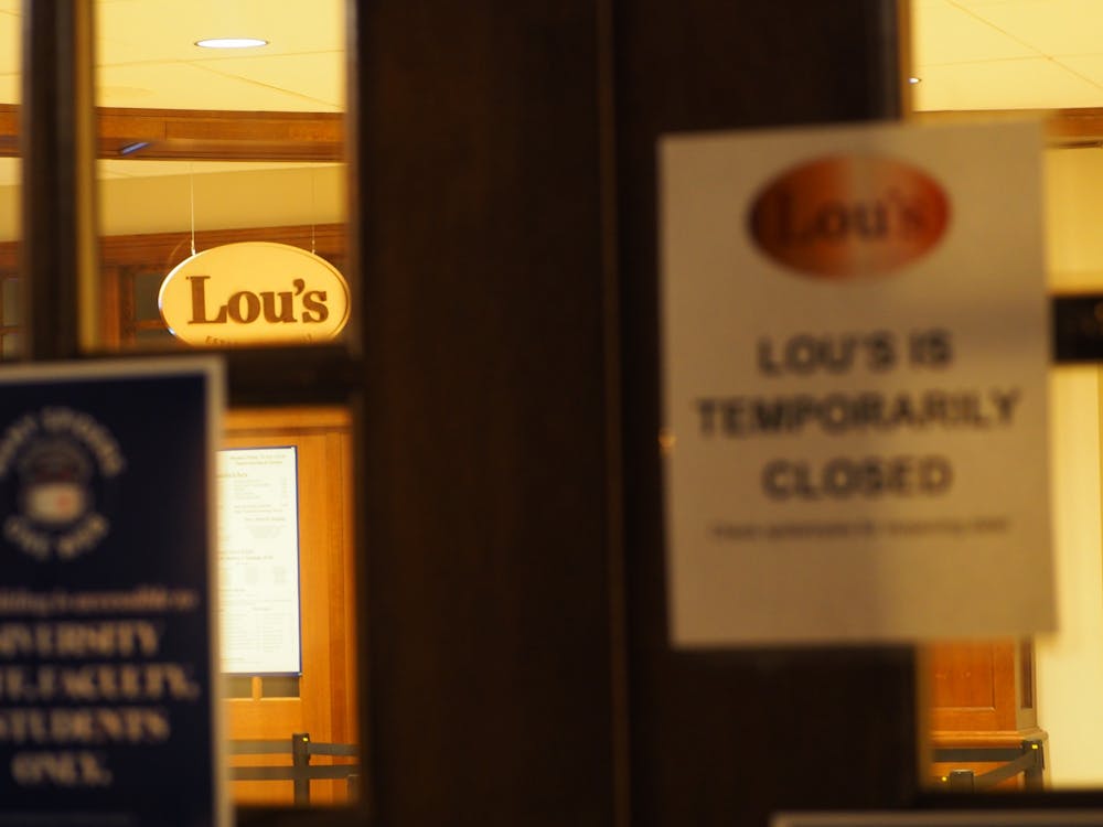 <p>The doors and signage of Lou's Cafe. The University will lose Lou's for a month before it reopens.&nbsp;</p>
