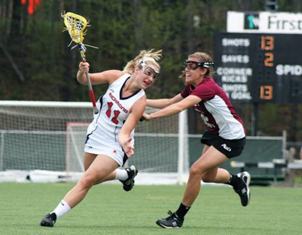 Freshman Mary Flowers wards off a St. Joseph's defender in Sunday's game.  The Spiders soundly beat the Hawks 12-5.