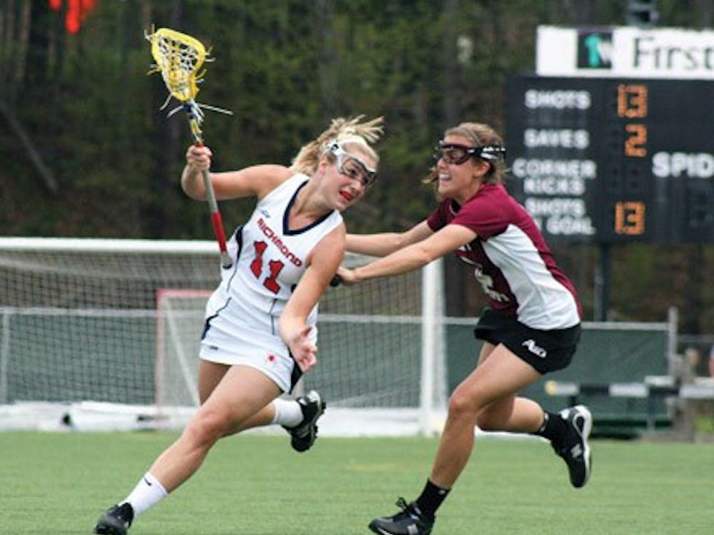 Freshman Mary Flowers wards off a St. Joseph's defender in Sunday's game.  The Spiders soundly beat the Hawks 12-5.