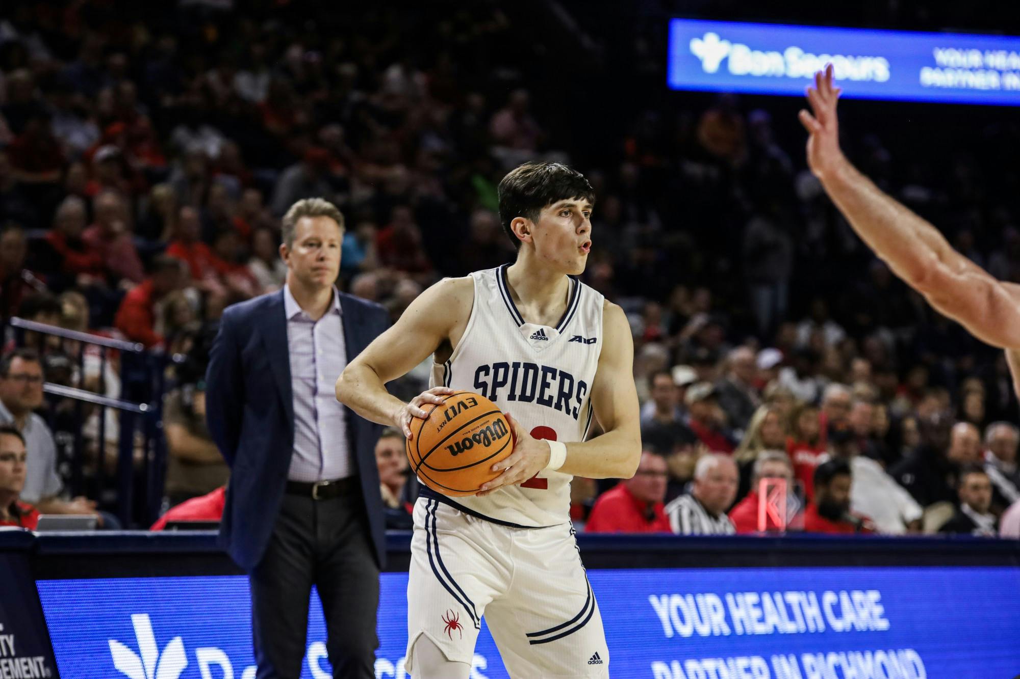 Graduate guard Andre Gustavson looks for a teammate to pass the ball to at the season opener game against Virginia Military Institute on Nov. 7.