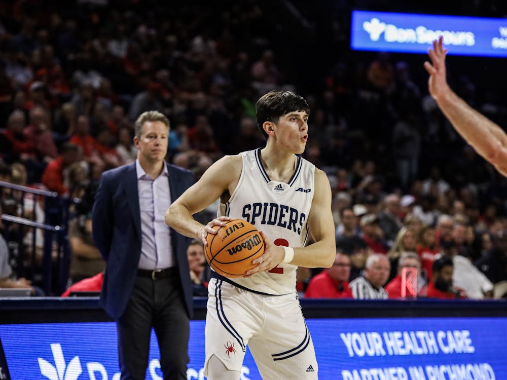 Graduate guard Andre Gustavson looks for a teammate to pass the ball to at the season opener game against Virginia Military Institute on Nov. 7.