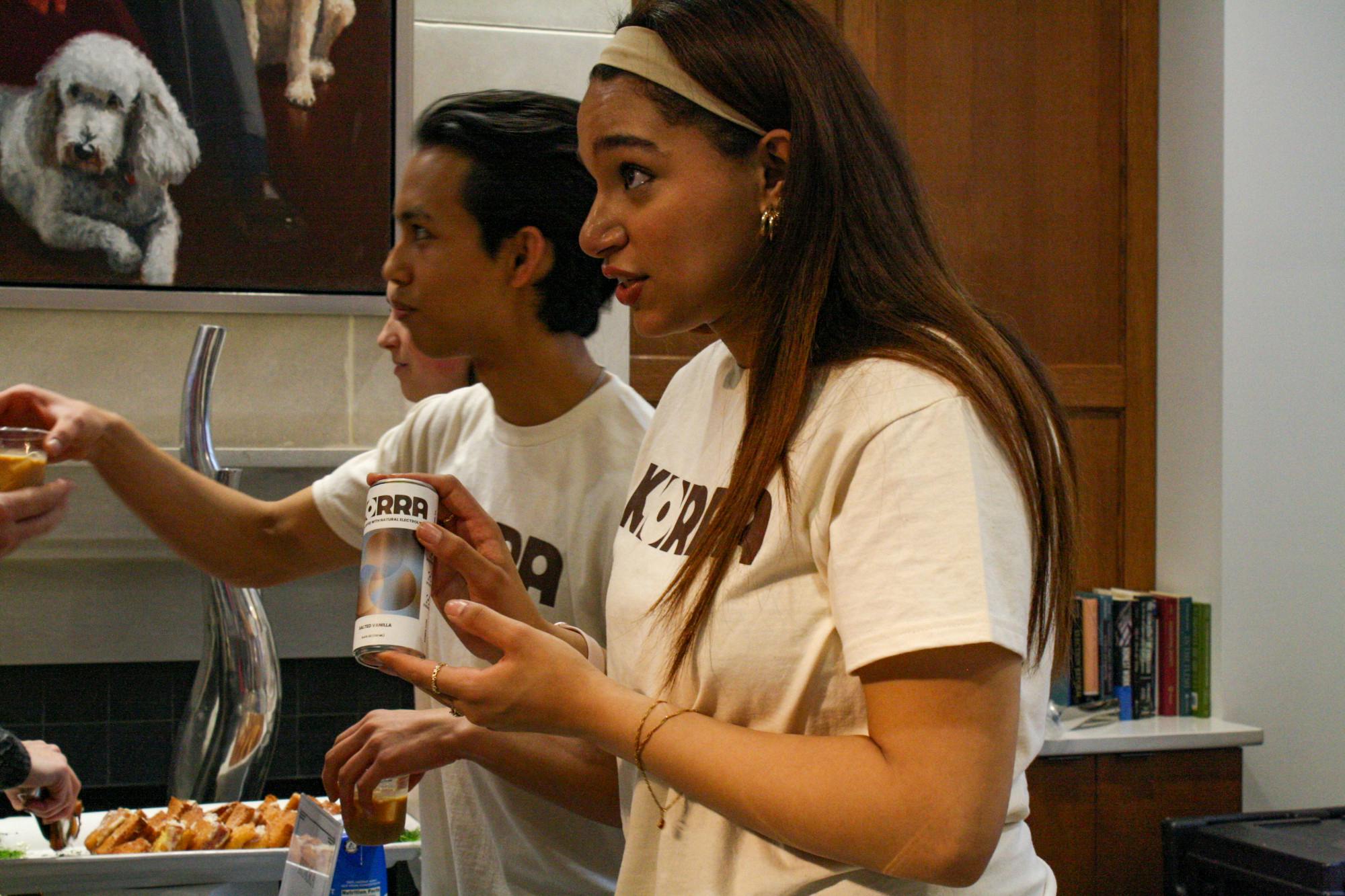 Seniors Ayah Karar, right, and Sequoia Kunkel, hand out samples of their winning product at the Bench Top bake-off on Tuesday, Oct. 28.