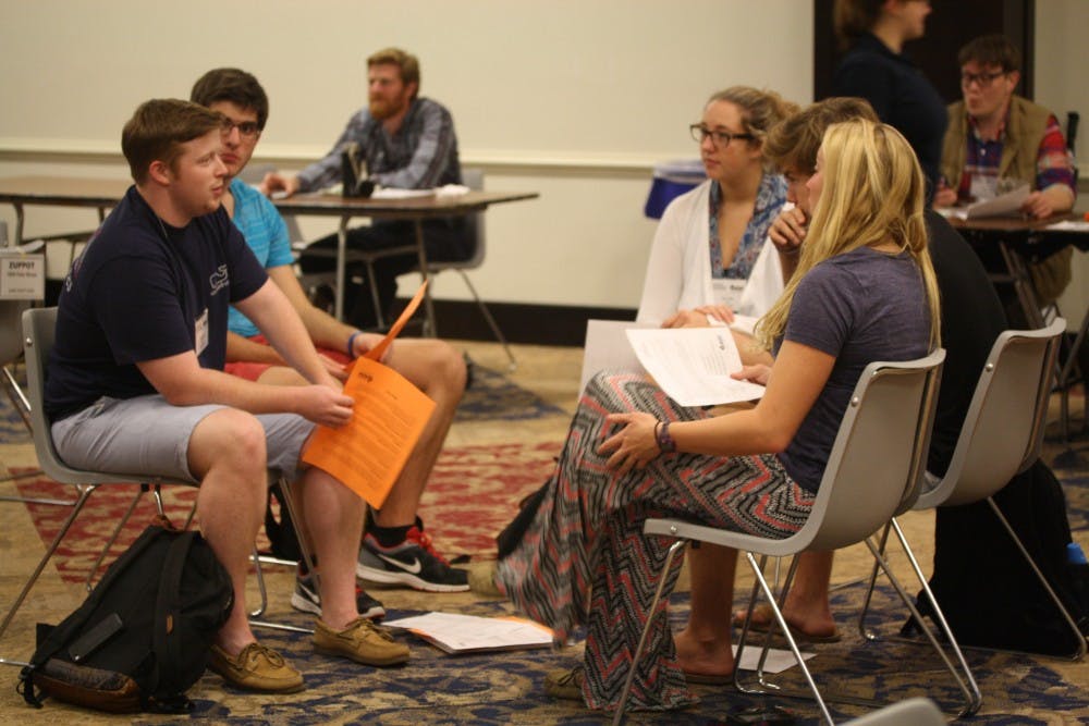 Students discuss their thoughts on the Poverty Simulation in the Alice Haynes Room. Photo by Anna Cable.