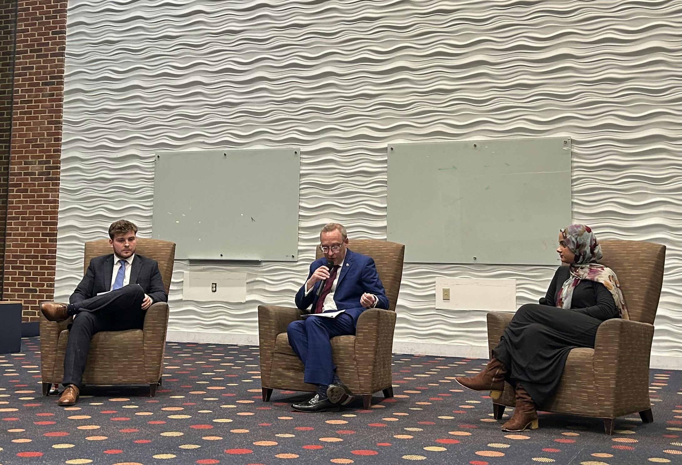 President Kevin Hallock, center, answers questions with Richmond College Student Government President Alfie Price, left and Westhampton College Student Government President Amal Ali, right.