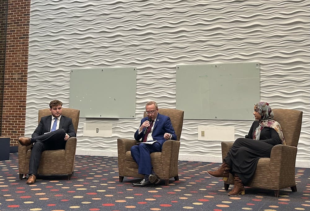 President Kevin Hallock, center, answers questions with Richmond College Student Government President Alfie Price, left and Westhampton College Student Government President Amal Ali, right.