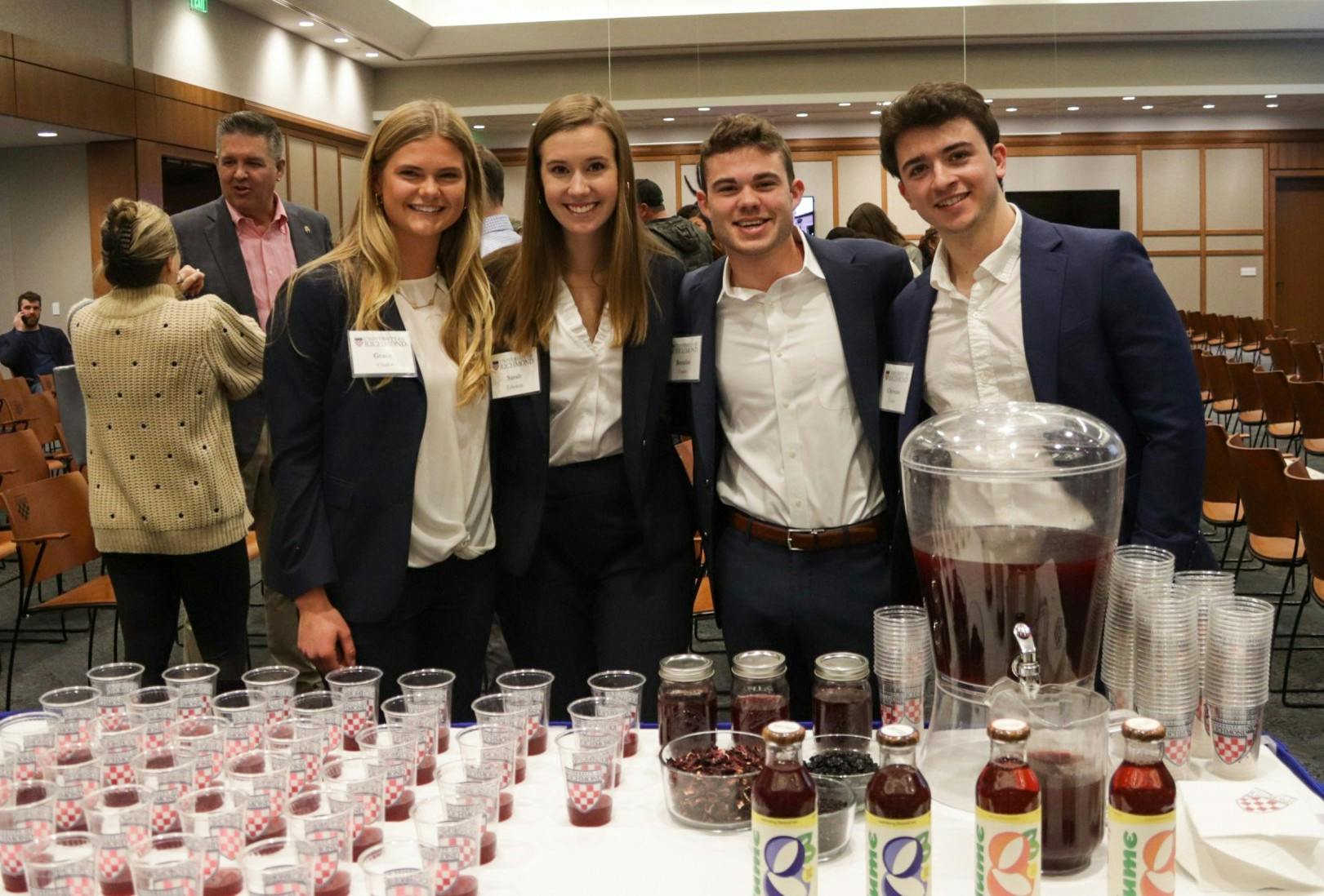 From left to right junior Grace Clarke, senior Sarah Edwards, Brendan Fowler and Chris Conte. The Lume co-founders pose with samples of their energizing tea at The Great Bake Off on Nov. 16.