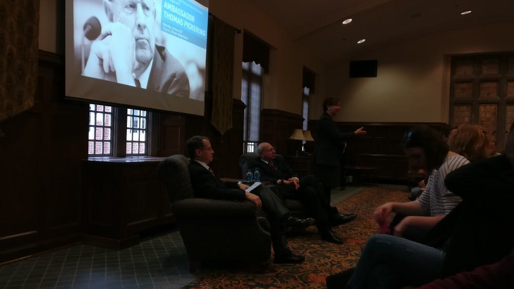 <p>Thomas Pickering and Stephen Long wait&nbsp;for dialogue as Dean of International Education&nbsp;Martha Merritt gives an introduction.</p>