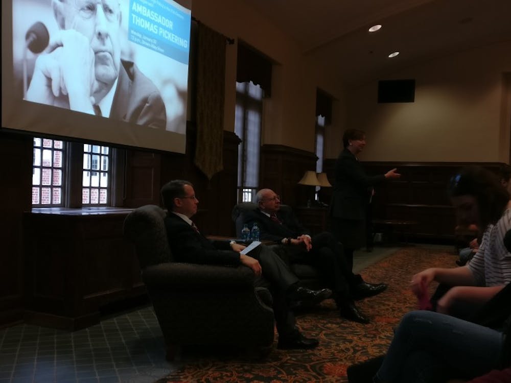 Thomas Pickering and Stephen Long wait for dialogue as Dean of International Education Martha Merritt gives an introduction.