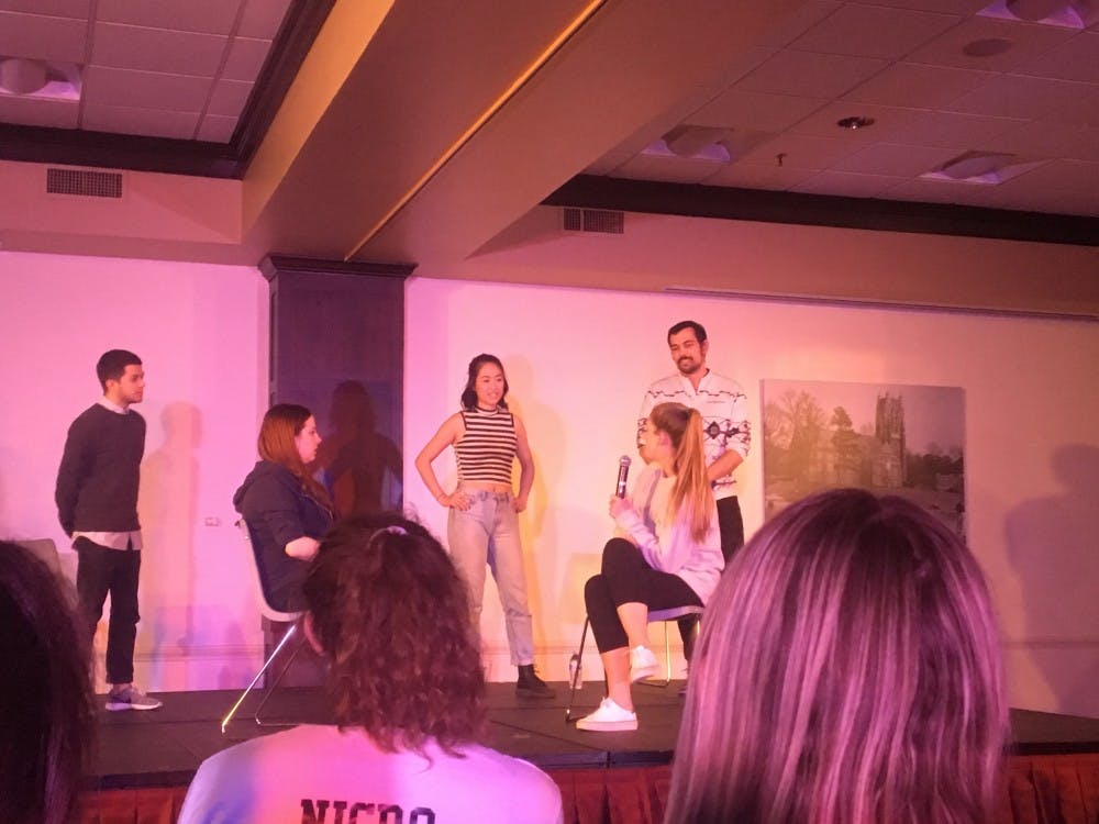 A student from the audience provides information for members of the&nbsp;Upright Citizens Brigade to base their sketch off of.&nbsp;