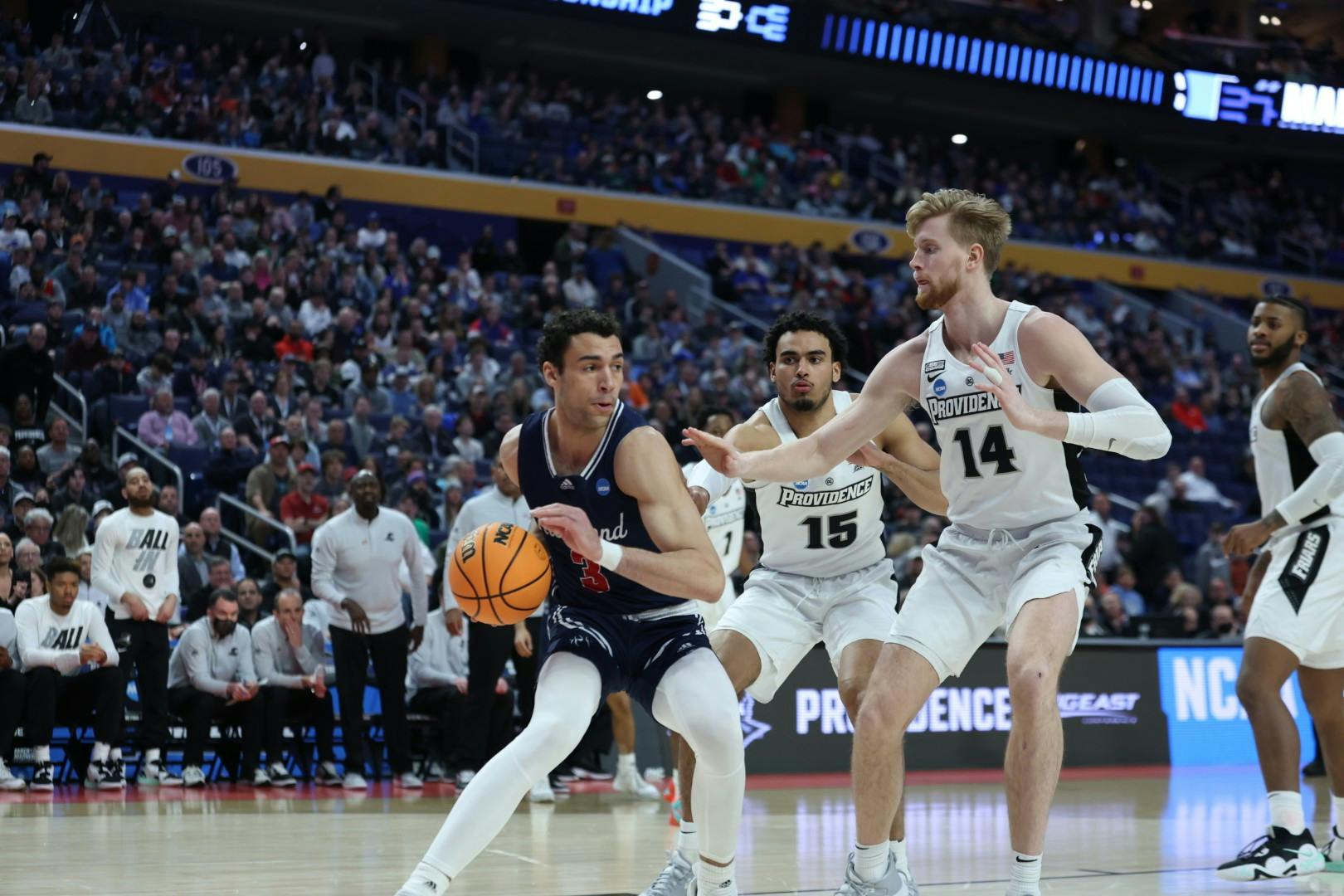 Junior forward Tyler Burton defends the ball from Providence College players at the second round of the NCAA tournament on March 20 at the KeyBank Center in Buffalo, New York. Photo courtesy of Richmond Athletics.