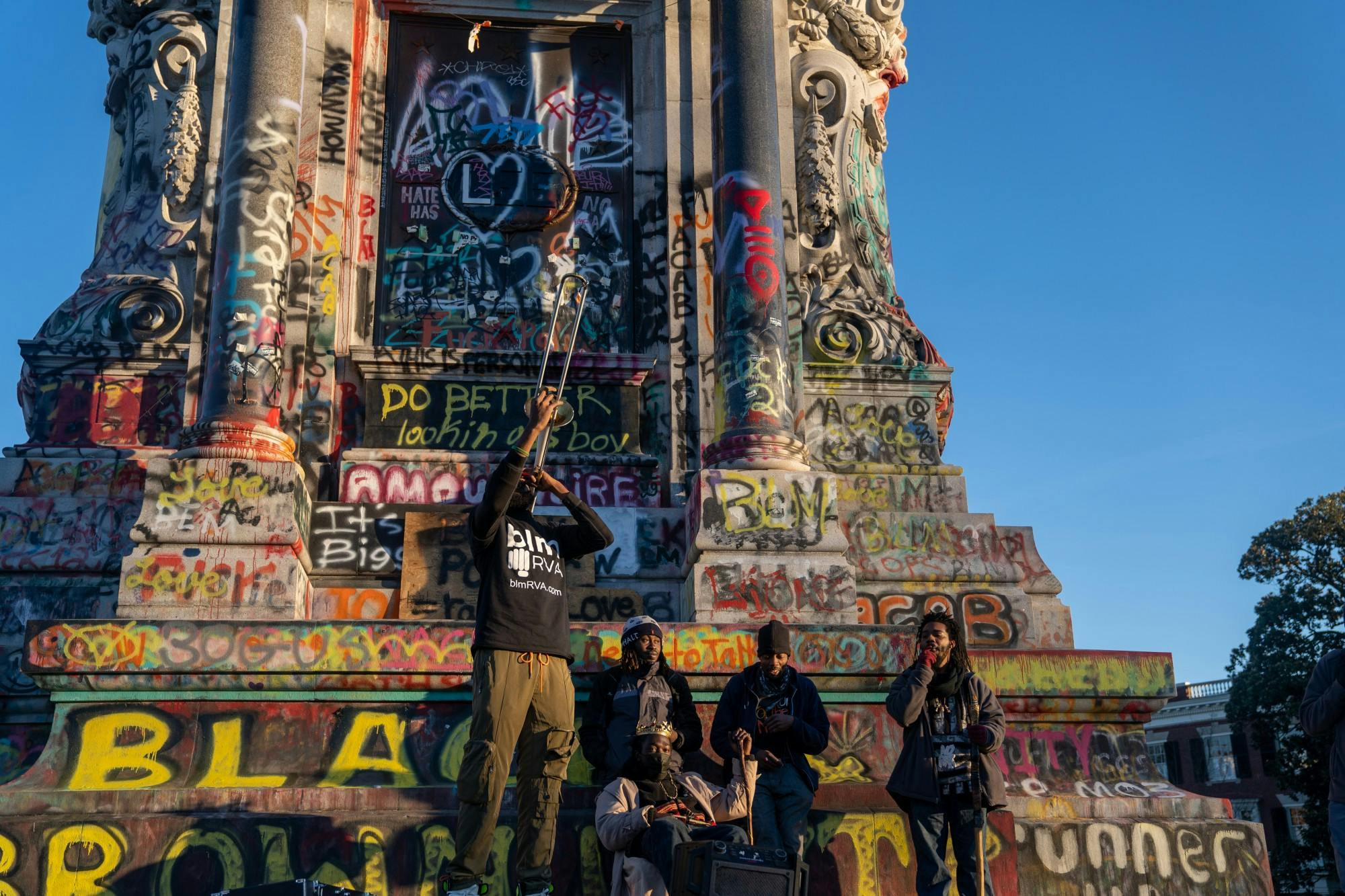 Members of BLMRVA perform jazz on the Robert E. Lee Statue in, what is now known as, Marcus David Peters Circle on Jan. 20.