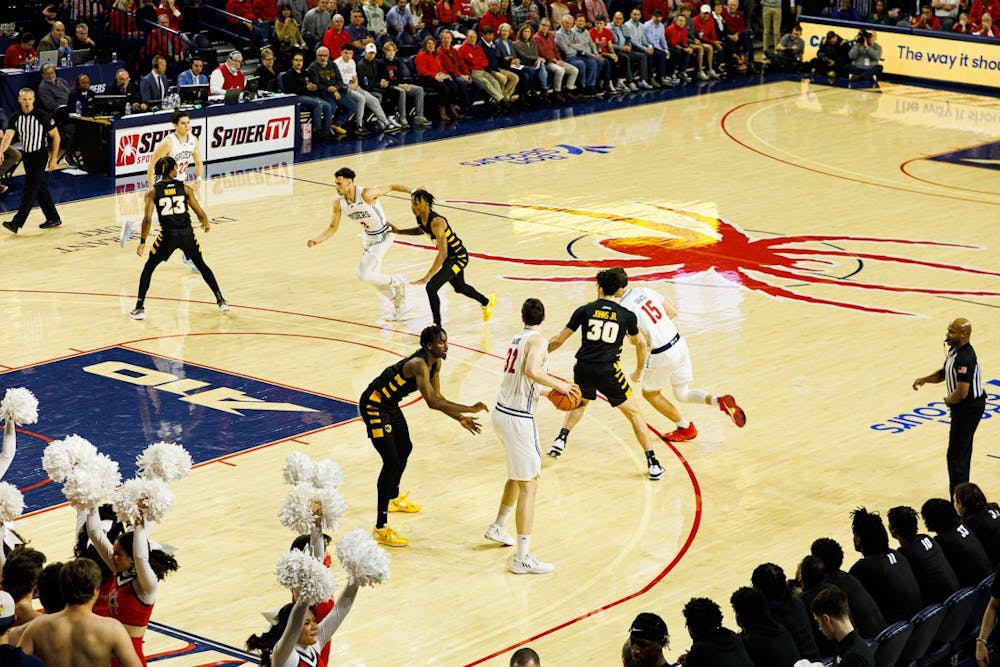 <p>Senior Center, Neal Quinn looks for a teammate to pass the ball to in the first quarter against VCU.</p>